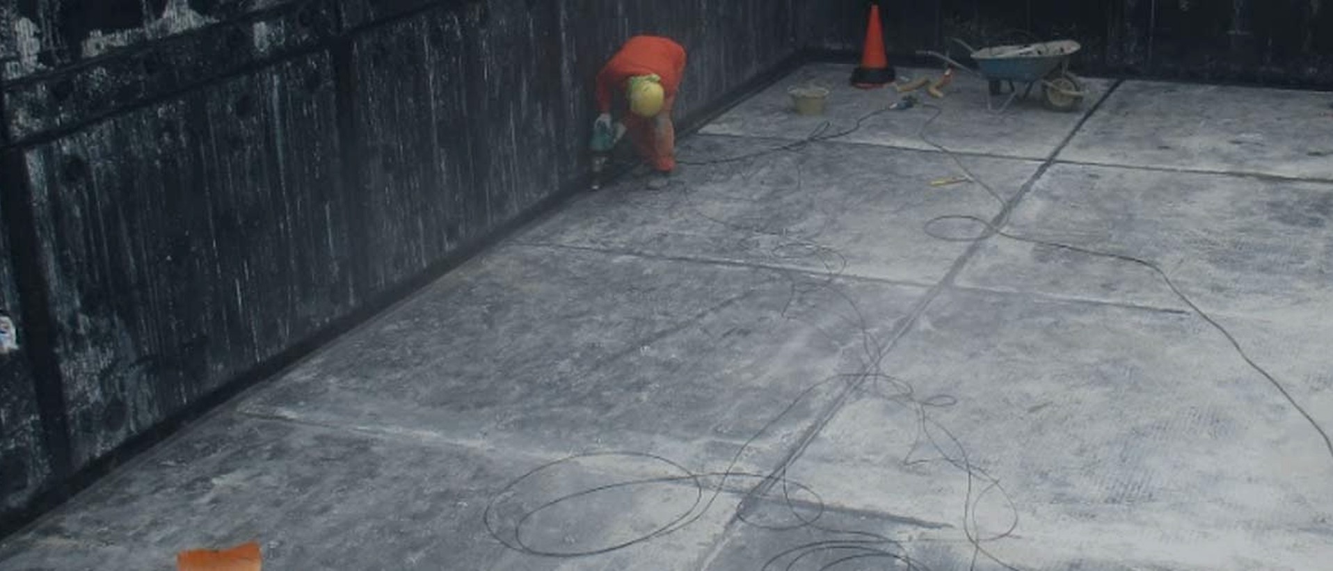 Stormwater applying a waterproofing system to a concrete deck on site in Singapore